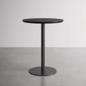 Premium Modern Round Height Dining Table in a minimalist matte black finish, showcasing a circular top panel supported by a central metal pedestal pillar column and a heavy-duty floor-flush circular disc base, standing flat on smooth grey concrete studio flooring against an off-white background wall.