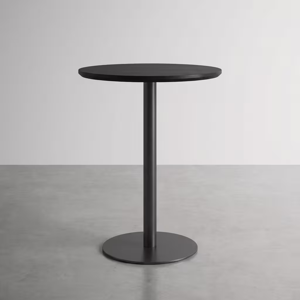 Premium Modern Round Height Dining Table in a minimalist matte black finish, showcasing a circular top panel supported by a central metal pedestal pillar column and a heavy-duty floor-flush circular disc base, standing flat on smooth grey concrete studio flooring against an off-white background wall.