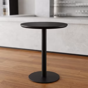 Premium Modern Round Height Dining Table in a minimalist matte black finish, showcasing a circular top panel supported by a central metal pedestal pillar column and a heavy-duty floor-flush circular disc base, standing flat on smooth grey concrete studio flooring against an off-white background wall.
