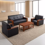 Premium Executive 5-Seater Office Sofa Set featuring a 3-seater sofa and two single-seater armchairs upholstered in button-tufted black leatherette with thick mahogany wood block armrests, arranged around a matching rectangular wooden two-tier coffee table on a large woven beige rug inside a modern corporate office lobby.