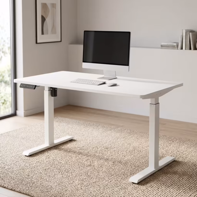 Premium 1.4M Adjustable Height Electric Table in an ultra-clean all-white finish, showcasing a spacious rectangular top panel holding an all-in-one computer screen, a silver wireless keyboard, and an optical mouse, featuring a digital keypad controller box on the front left margin, supported by a heavy-duty motorized steel T-frame lifting column base, resting on a textured woven beige area rug.