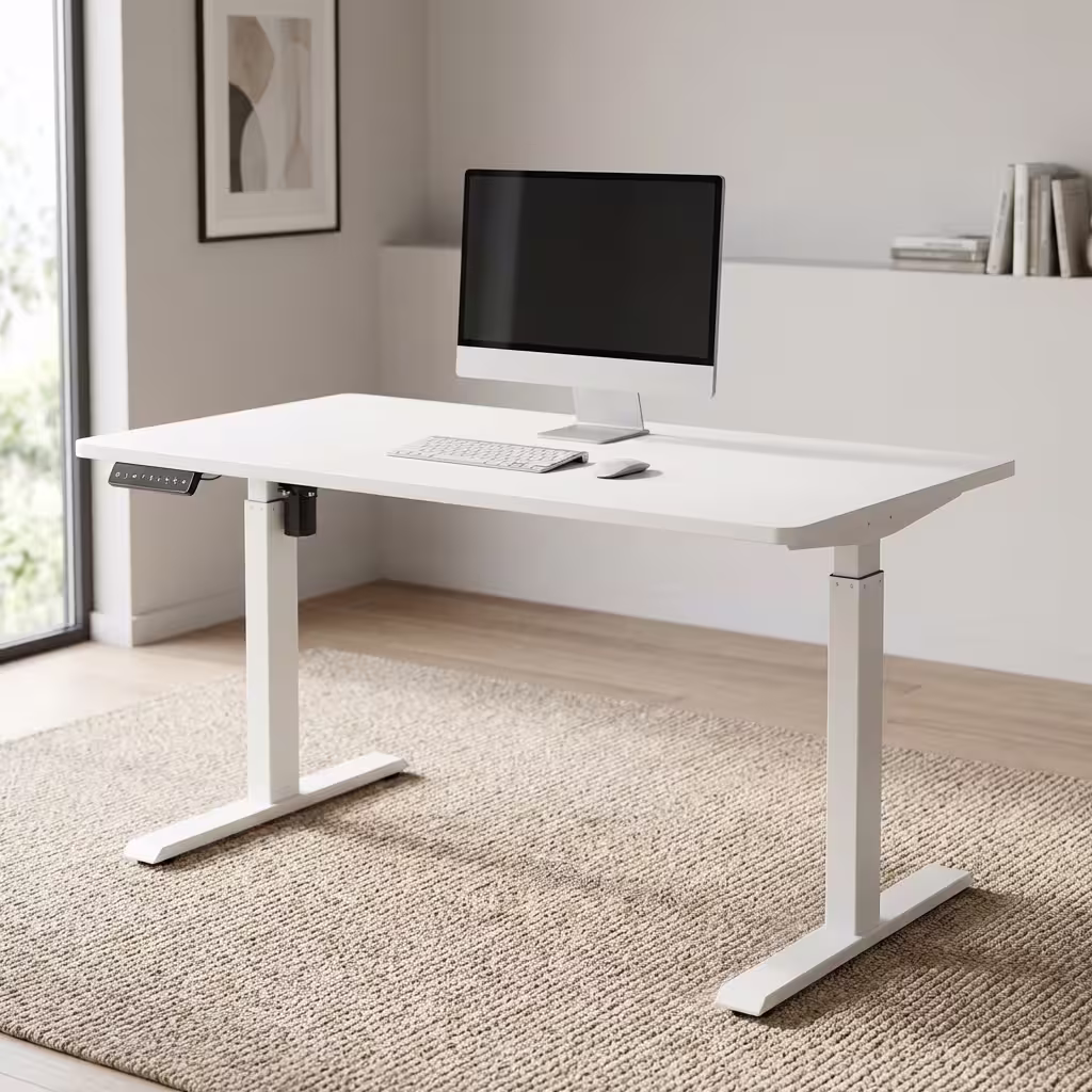 Premium 1.4M Adjustable Height Electric Table in an ultra-clean all-white finish, showcasing a spacious rectangular top panel holding an all-in-one computer screen, a silver wireless keyboard, and an optical mouse, featuring a digital keypad controller box on the front left margin, supported by a heavy-duty motorized steel T-frame lifting column base, resting on a textured woven beige area rug.