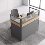 Premium 1.2M Single Modular Office Workstation featuring a solo desk layout with a light oak woodgrain desktop, wrapped on three sides by integrated matte grey privacy partition screens with a central woodgrain accent stripe and translucent horizontal-slatted glass toppers, paired with an ergonomic black office chair on a textured grey area rug inside a modern sunlit corporate office.
