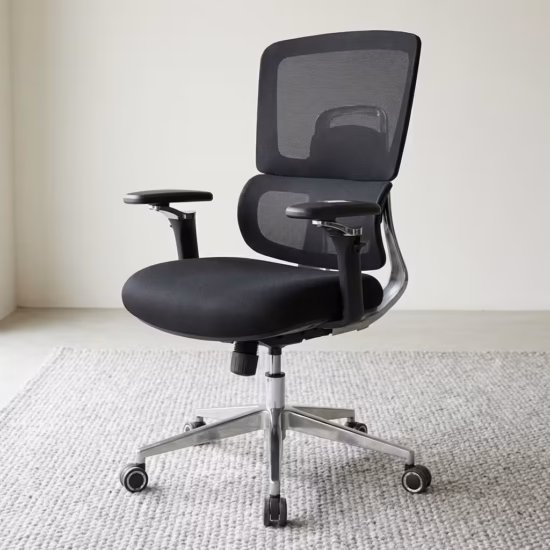 Premium Medium Back Orthopedic Mesh Office Chair featuring an open-airflow black mesh split backrest, flat black adjustable armrests with polished chrome support bars, a thick black fabric seat cushion, and a highly reflective polished metal five-star star base with rolling wheels, standing on a textured grey woven area rug.
