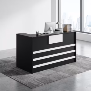 Premium 1400mm Custom Front Reception Office Desk in a bold matte black and white dual-tone finish, showing an integrated upper privacy counter holding an all-in-one computer screen, a silver articulating desk lamp, and binder organizers, detailed with three horizontal white front accent bands and a central white logo mount board, resting on a textured gray geometric carpet tile rug inside a sunlit skyscraper office room.