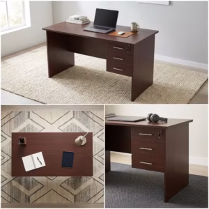Premium 1M Wooden Lockable Study Desk in a mahogany woodgrain finish, showcasing a spacious rectangular top panel holding an open laptop, a ceramic mug, and books, an integrated three-drawer right storage pedestal with silver handles and a key inserted in the top lock core, a white articulation desk lamp, resting on a textured cream area rug over light wood flooring.