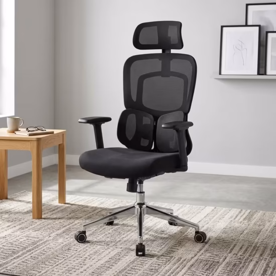 Premium High-Back Orthopedic Mesh Executive Office Chair featuring an open-airflow black mesh backrest, matching adjustable headrest, flat black T-shaped armrests, a unique dual-wing lower-back support layout, a plush black seat cushion, and a highly reflective polished chrome five-star star base with rolling wheels, standing on a textured light cream area rug.