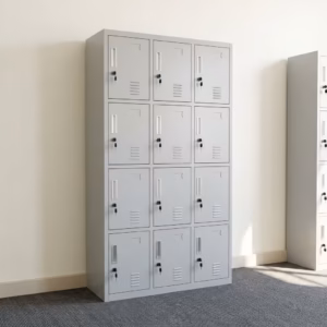 Premium 12-Locker Filing Steel Locker Cabinet in a professional light grey powder-coated steel finish, showcasing a 3x4 grid layout of twelve closed locker doors with recessed handles, cylinder locks with keys inserted, name card frames, and stamped bottom ventilation slits, standing flat on smooth light wood flooring against a textured grey background.