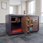 Premium 45Kg Fireproof Office Safe Box in a textured purple steel finish, showing its thick front vault door swung wide open to reveal a bronze-toned inner panel with three thick silver locking deadbolts, an integrated gold key-locked top compartment, a main storage cavity with a red felt base liner, and a front gold-accented digital electronic keypad lock, resting on blue textured office carpeting.