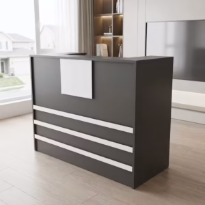 Premium 1400mm Custom Front Reception Office Desk in a bold matte black and white dual-tone finish, showing an integrated upper privacy counter holding an all-in-one computer screen, a silver articulating desk lamp, and binder organizers, detailed with three horizontal white front accent bands and a central white logo mount board, resting on a textured gray geometric carpet tile rug inside a sunlit skyscraper office room.