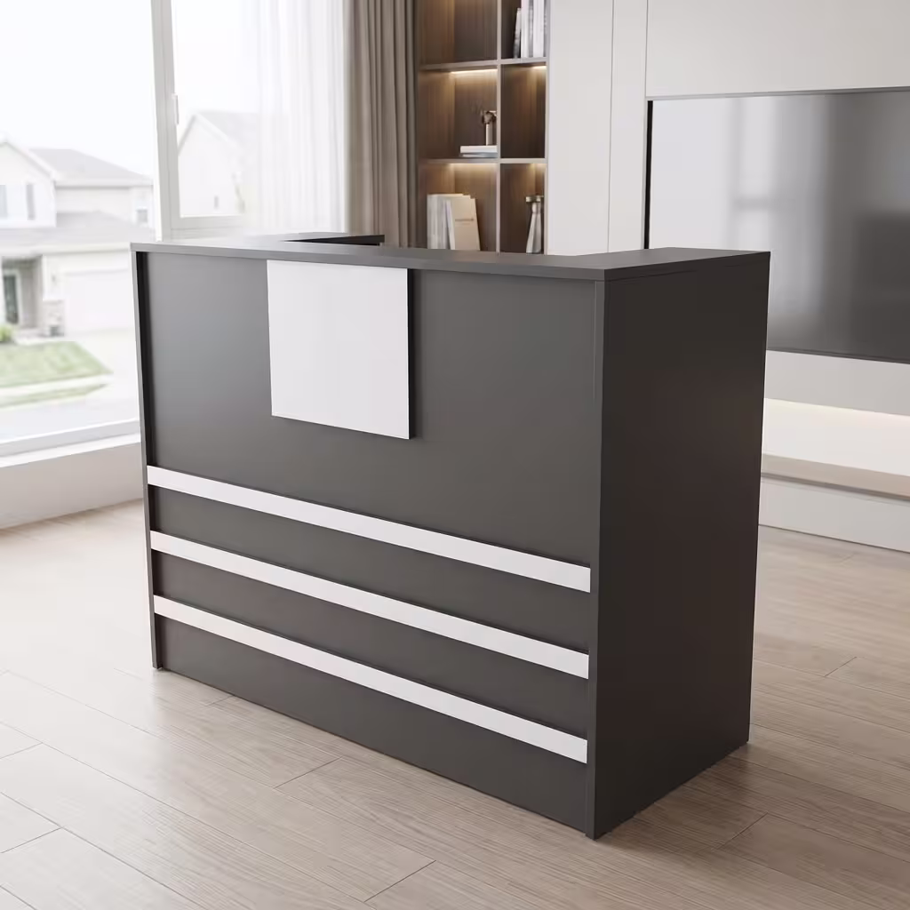 Premium 1400mm Custom Front Reception Office Desk in a bold matte black and white dual-tone finish, showing an integrated upper privacy counter holding an all-in-one computer screen, a silver articulating desk lamp, and binder organizers, detailed with three horizontal white front accent bands and a central white logo mount board, resting on a textured gray geometric carpet tile rug inside a sunlit skyscraper office room.