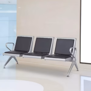 Premium 3-Seater Padded Metallic Waiting Bench featuring three linked silver metallic chairs with black padded leatherette seats and backrests, integrated curved aluminum-alloy side armrests, and sturdy silver metal triangle legs with adjustable leveling glides, standing on a reflective white floor inside a modern corporate reception room.
