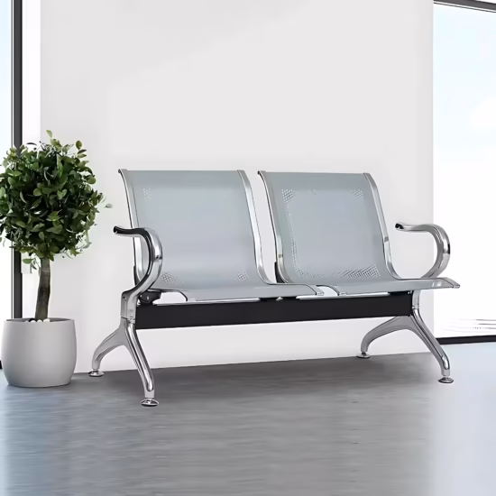 Premium 2-Link Steel Office Waiting Bench featuring two linked silver metallic chairs with perforated mesh patterns, integrated curved polished chrome side armrests, and sturdy silver metal arching legs with adjustable leveling glides, standing on a textured tan woven rug inside a modern corporate reception room.