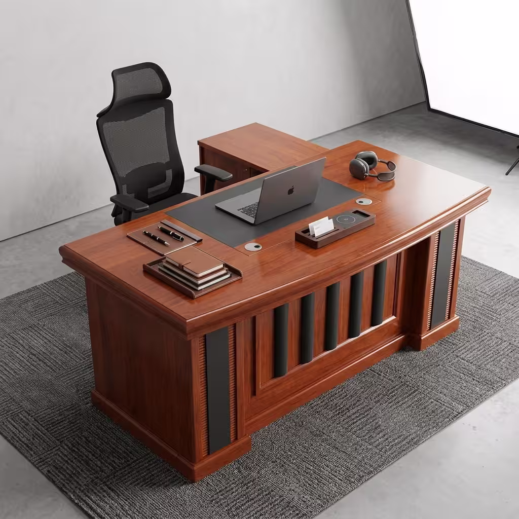 Executive 160cm L-Shaped Office Desk in a rich cherry wood finish with black leather desk padding and a decorative panel front, paired with an ergonomic chair.