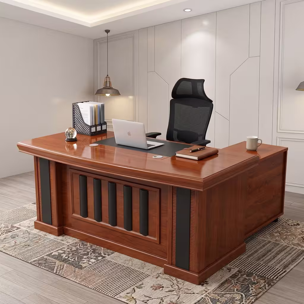 Executive 160cm L-Shaped Office Desk in a rich cherry wood finish with black leather desk padding and a decorative panel front, paired with an ergonomic chair.