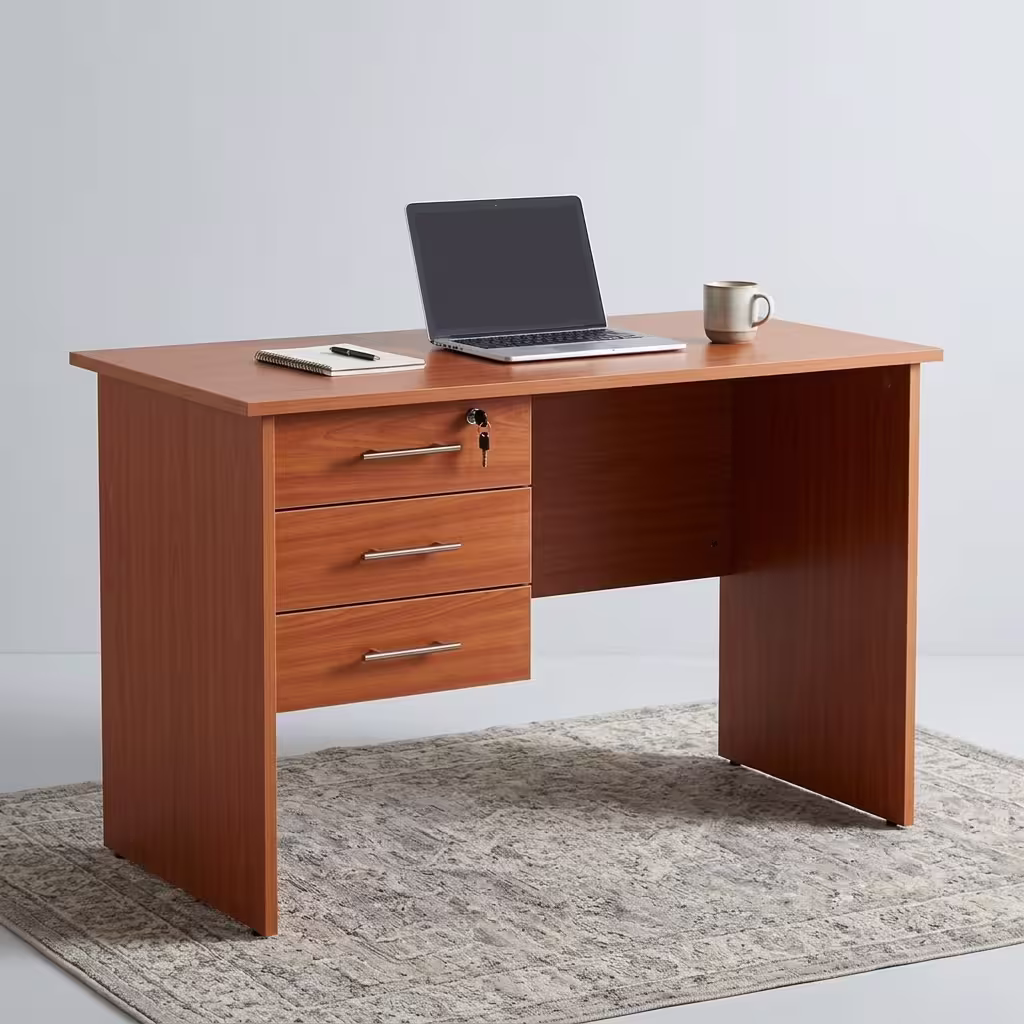 1M 3-Drawer Home/Office Study Desk in a warm oak wood grain finish featuring a lockable top drawer, sleek metallic handles, and an open knee space on a patterned rug.