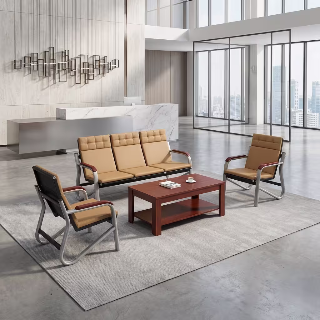 Premium Executive 5-Seater Reception Sofa Set featuring a 3-seater tandem sofa and two single-seater armchairs upholstered in tan segmented leatherette with chrome cantilever frames and dark wood armrests, arranged around a matching rectangular wooden two-tier coffee table on a polished concrete floor inside a modern corporate office lobby.