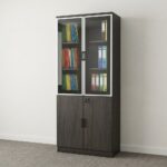 A tall, vertical 2-Door Half-Glass Wooden Cabinet in a dark brown wood-grain finish featuring aluminum-framed glass upper doors filled with binders and a lockable solid wood lower cabinet in a modern office.