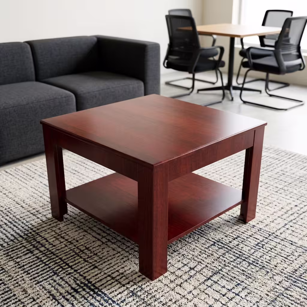 0.6m Square Wooden Office Coffee Table with a built-in lower shelf in a warm mahogany finish, placed on a patterned rug next to an office sofa.