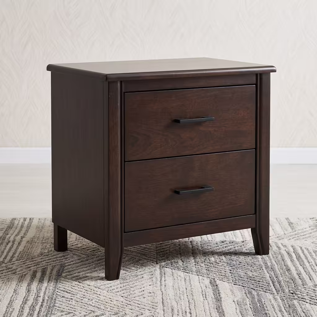 Close-up view of a 2-Drawer Wooden Side Bed Table in an espresso finish, highlighting its modern matte-black hardware on a cream rug.