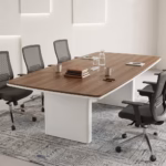 2.4m Executive Office Boardroom Table featuring a warm walnut wood top, modern white curved pedestal legs, and clean white edge banding, paired with mesh office chairs.
