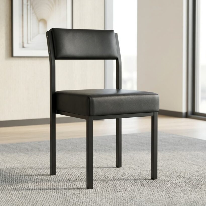 A minimalist black executive guest chair featuring a thick square padded seat cushion and a matching rectangular padded backrest, supported by a sleek black metal frame with four straight square legs.