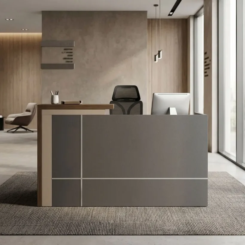 A premium 1.8m Reception Desk featuring a matte gray front facade with thin metallic grid accents, a cream side column, a polished wood-grain transaction counter, and an ergonomic black mesh office chair positioned behind the desk.